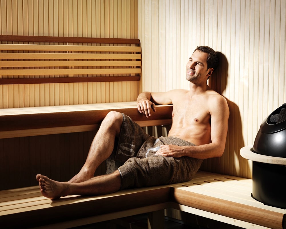 man in a wooden sauna